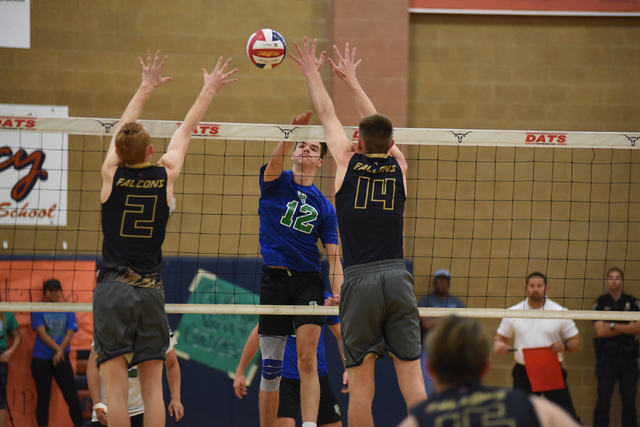 Green Valley’s Chase Larson (12) spikes the ball against Foothill’s Mason Hansen ...