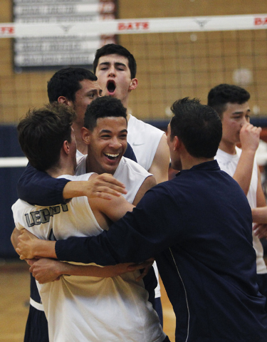 Legacy’s Anthony Madden, front middle, hugs teammate Tanner Compton, left, as their te ...