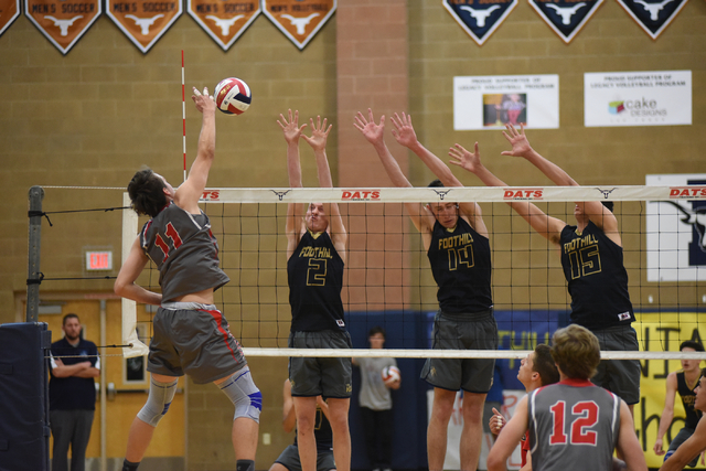 Arbor View’s Treven Clizbe (11) spikes the ball against Foothill’s Mason Hansen ...