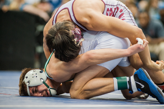 Green Valley High School’s Jared Brathor, bottom, wrestles Cimarron-Memorial’s A ...