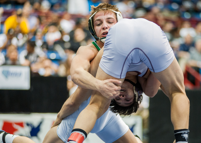 Green Valley High School’s Jared Brathor, top, wrestles Cimarron-Memorial’s Ange ...