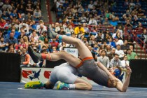 Green Valley High School’s Josh Temple, left, slams Bishop Gorman’s Mason Campbe ...