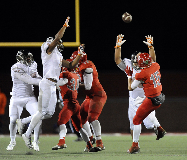 Bishop Gorman’s Ethan Palelei, right, and Alize Jones (8) rush Arbor View quarterback ...