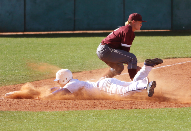 Bishop Gorman’s Matt Hudgins dives into third as Cimarron-Memorial’s Trevor Lipp ...