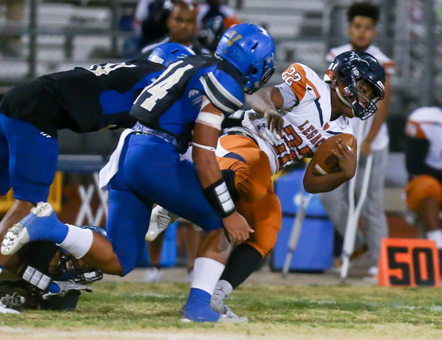 Legacy’s Samuel Turner (22) is tripped up by Sierra Vista defense during a Sunset Regi ...