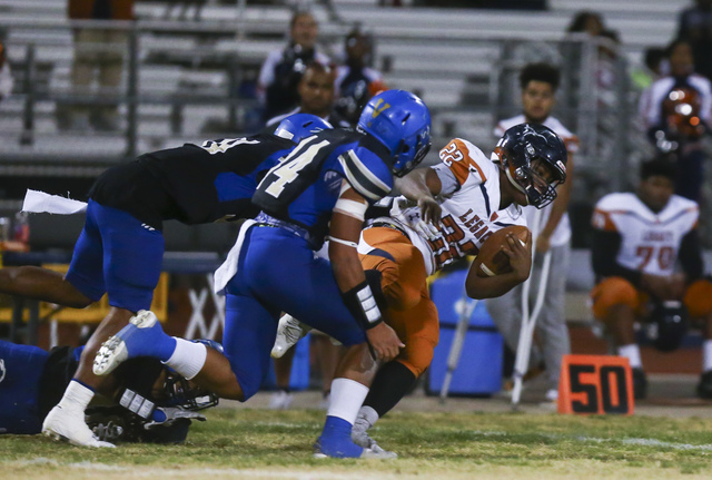 Legacy’s Samuel Turner (22) is tripped up by Sierra Vista defense during a Sunset Regi ...