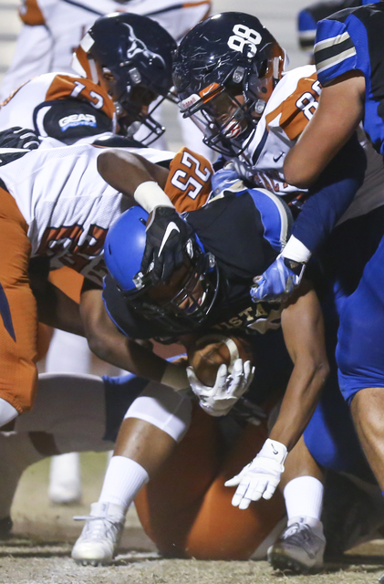 Sierra Vista’s Isaiah Zavala (25) is tackled by Legacy defense, including Legacy&#8217 ...