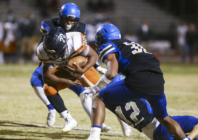 Legacy’s Samuel Turner (22) is tackled by Sierra Vista’s Trevor Gentner (12) dur ...