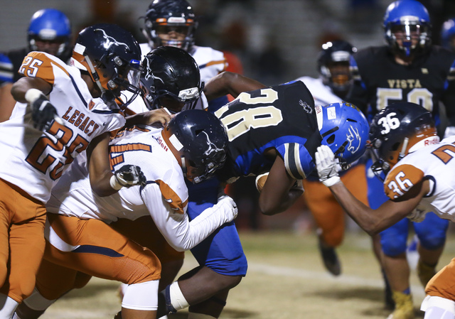 Sierra Vista’s Bryan LaGrange (28) is tackled by Legacy defense during a Sunset Region ...