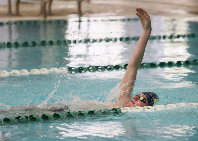 Faith Lutheran senior Bowen Becker, 17, swims the backstroke during a warm-up at practice at ...