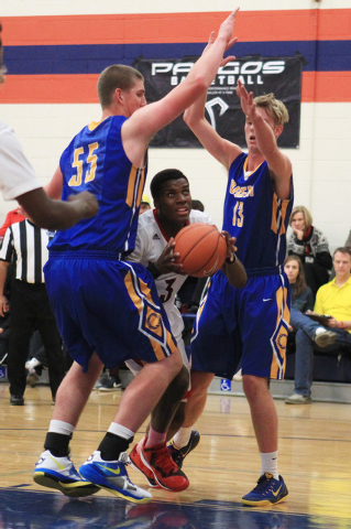 Las Vegas guard Tyshon Raybon sneaks between Orem center Richard Harward, left, and forward ...