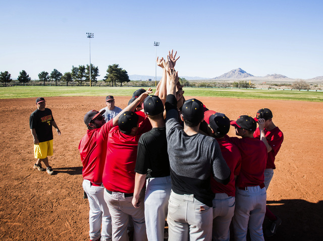 Tech baseball coach Bill Stuber, left, watches his team huddle during practice at the Silver ...