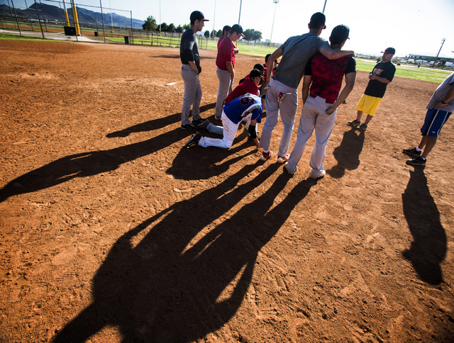 Tech baseball coach Bill Stuber, right, talks to his team during practice at the Silver Bowl ...