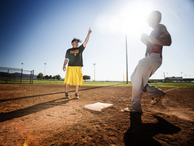 Tech baseball coach Bill Stuber, left, runs baserunning drills during practice at the Silver ...