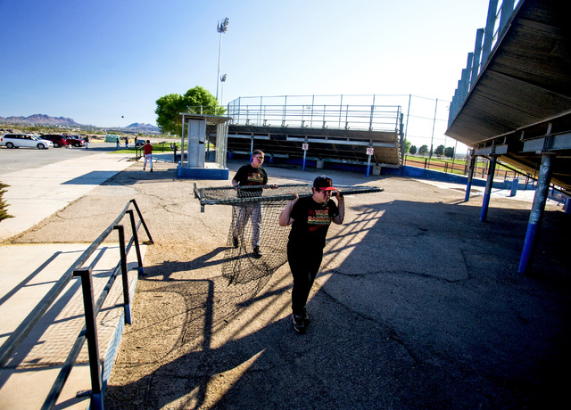 Tech junior varsity baseball players Casey Brokaw, 15, and Mathew O’Keefe carry a batt ...