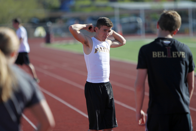 Faith Lutheran runner Mark Rubalcaba, 18, takes a break during a track practice at Faith Lut ...