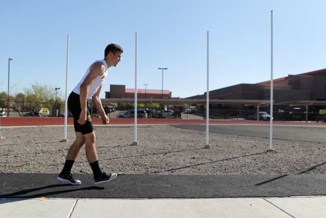 Faith Lutheran runner Mark Rubalcaba, 18, works on his long jumps during a track practice at ...