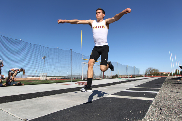 Faith Lutheran runner Mark Rubalcaba, 18, works on his long jumps during a track practice at ...