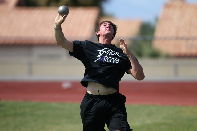 Brady Williams, 18, practices the shot put during a practice at Green Valley High School in ...