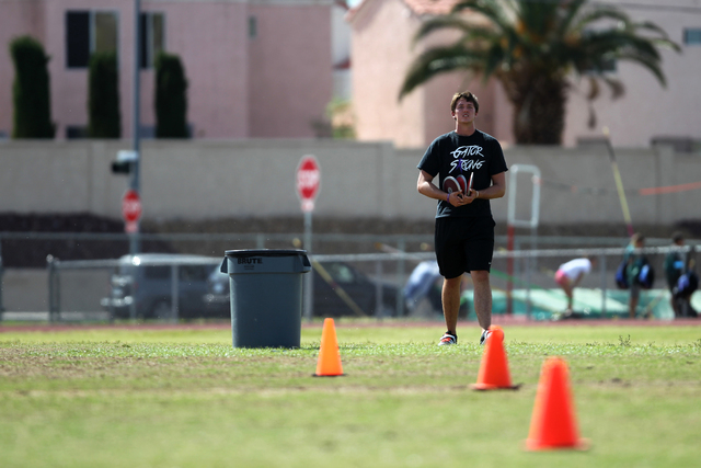 Brady Williams, 18, walks after picking up discus he threw during a practice at Green Valley ...