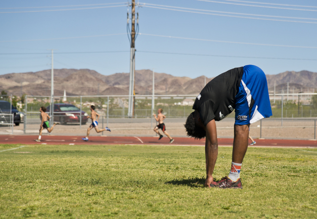 Basic High School high jumper Frank Harris stretches during track practice at Basic High Sch ...