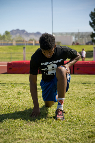 Basic High School high jumper Frank Harris stretches during track practice at Basic High Sch ...