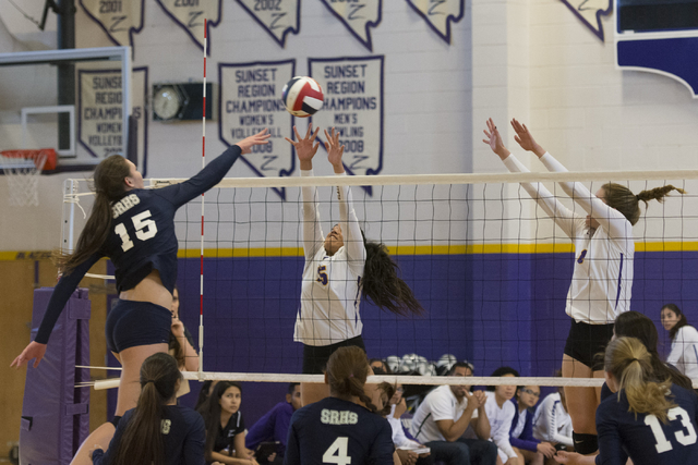 Shadow Ridge’s Whittnee Nihipali (15), left, hits the ball against Durango during a Su ...