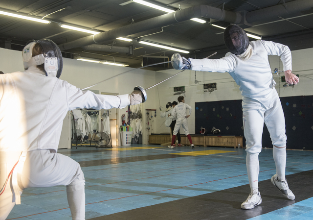 Bishop Gorman fencer Zachary Zeller fences with an opponent during practice inside the Fenci ...