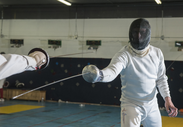 Bishop Gorman fencer Zachary Zeller fences with an opponent during practice inside the Fenci ...