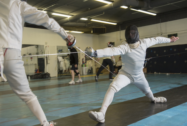 Bishop Gorman fencer Zachary Zeller fences with an opponent during practice inside the Fenci ...