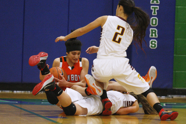 Chaparral guard Abigail Delgado falls over Dimond guard Nikki Forrey during the Gator Winter ...