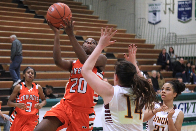 Chaparral guard Marcia Hawkins drives to the basket while being defended by Dimond center Le ...