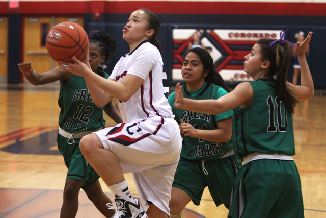 Coronado guard Dajah Washington drives past Green Valley’s Jamaica Lewis, left, Vivias ...