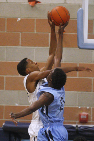 Canyon Springs forward D’Quan Crockett blocks a shot by Foothill forward Torrance Litt ...