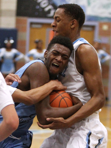 Canyon Springs forward D’Quan Crockett is defended by Foothill guard Eric Johnson (hid ...