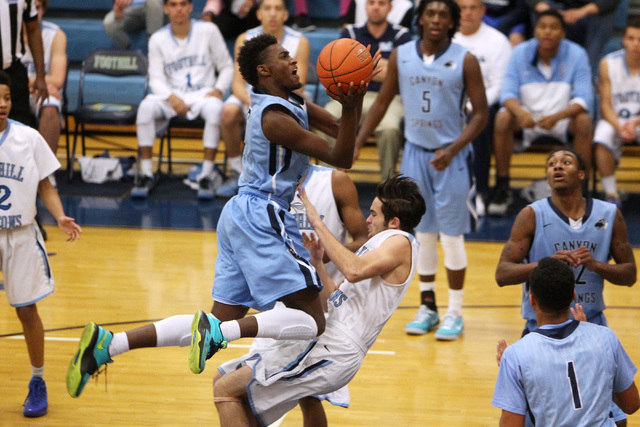 Canyon Springs forward D’Quan Crockett draws a foul on Foothill forward Josh Kidd duri ...