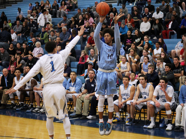 Canyon Springs guard Zaahid Muhammad takes a 3-point shot while being defended by Foothill g ...