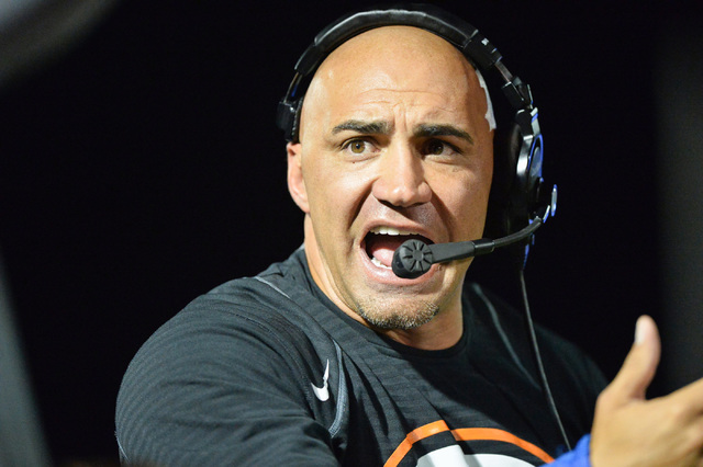 Bishop Gorman head coach Kenny Sanchez talks to an assistant coach during the Bishop Gorman ...