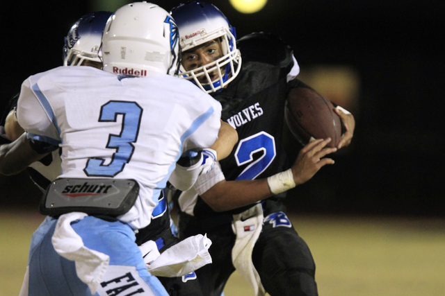 Basic quarterback Aeneas McAllister looks to get past Foothill defensive back Devin Smith du ...