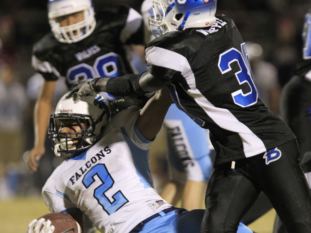 Basic defensive end Wallonzo Whipple stops Foothill running back Bobby Merritt during the fi ...