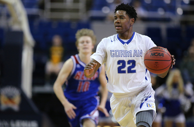 Bishop Gorman’s Christian Popoola Jr. brings the ball up the court against Reno during ...