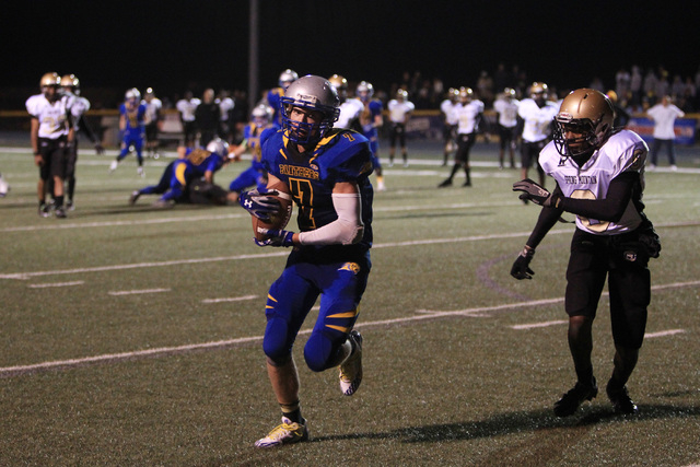 Pahranagat Valley tight end Shawn Wadsworth pulls in a touchdown pass while being covered by ...