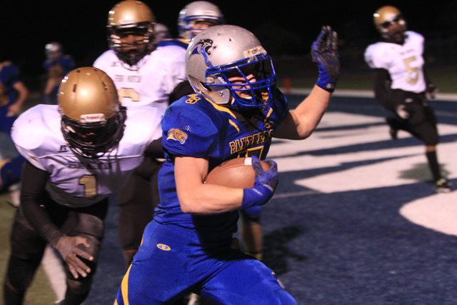 Pahranagat Valley running back Wade Leavitt gets past Spring Mountain linebacker Nick Myers ...