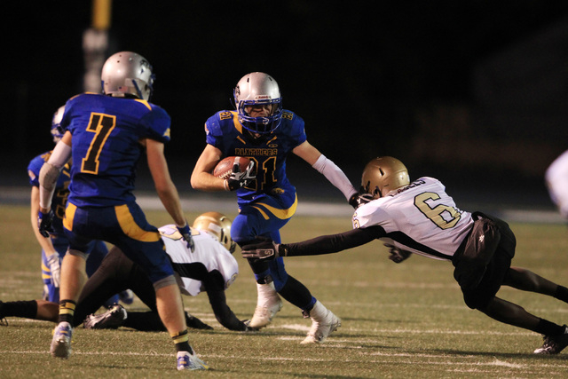 Pahranagat Valley running back Jordan Cryts gets past Spring Mountain linebacker Maurice Sti ...