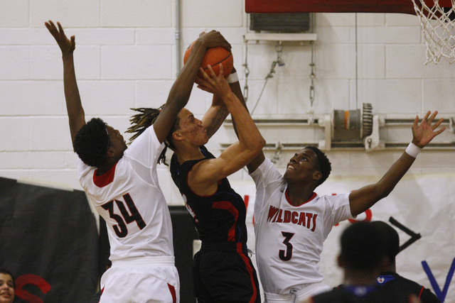 Valley forward Taveon Jackson has his shot blocked by Las Vegas forward Marquise Raybon, lef ...