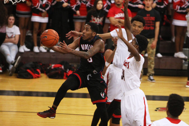 Valley guard Cameron Burton drives to the basket past the Las Vegas defense during their &qu ...