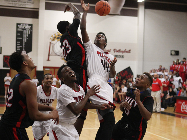 Valley forward Nick Brannon blocks a shot by Las Vegas forward Will Loche during their &quot ...