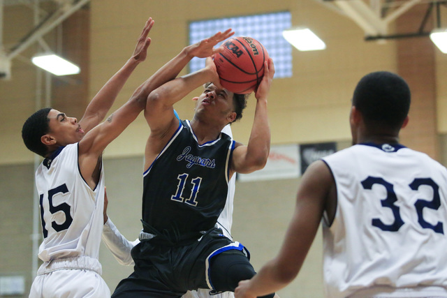 Desert Pines senior Capri Uzan (11) takes a shot during the Class 3A boys regional basketbal ...