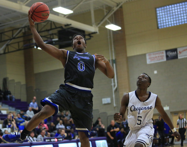 Desert Pines senior Jewell Springer (0) shoots a lay up during the Class 3A boys regional ba ...