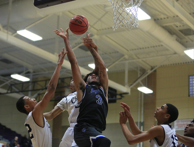 Desert Pines senior Trevon Abdullah (3) is fouled while taking a shot during the Class 3A bo ...